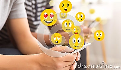 Social concept. Teen guy using smartphone sending emojis Stock Photo