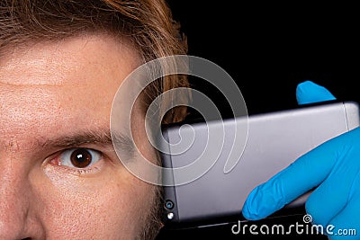 Social crisis depression psychological problems concept close male portrait brown eye and mobile phone near head on black Stock Photo