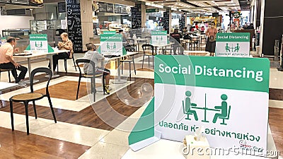 Social distancing for COVID-19 disease pandemic prevention in Tesco Lotus food court dining table public area for keeping people Editorial Stock Photo