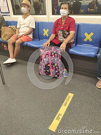 Social distancing during Covid-19 pandemic on public transport BTS train, Bangkok, Thailand Editorial Stock Photo