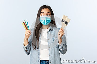 Social distancing lifestyle, covid-19 pandemic, self-isolation hobbies and leisure concept. Excited creative asian girl Stock Photo