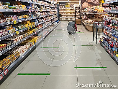 Social distancing tape lines across a supermarket floor Editorial Stock Photo