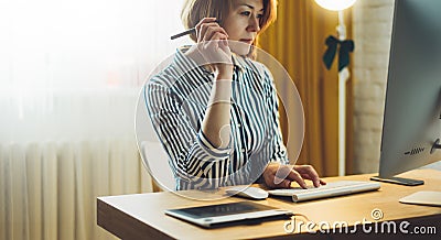 Social isolation girl working at home with monitor computer, manager typing on keyboard, work process concept indoors workplace Stock Photo