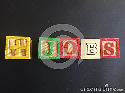 Word Jobs composed by wooden cubes on black background Stock Photo