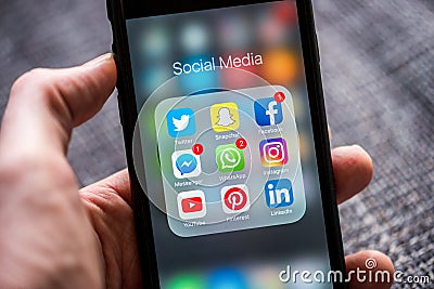 Social media app icons displayed on Apple iPhone Editorial Stock Photo