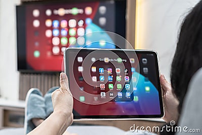 Social media app icons on ipad, digital tablet screen, smart mobile internet network application technology Editorial Stock Photo