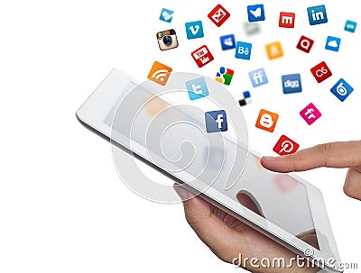 Social media icons fly off the ipad in hand Editorial Stock Photo