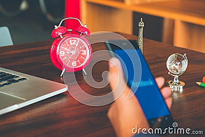 Social media time management concept, Alarm clock and hand hold Editorial Stock Photo