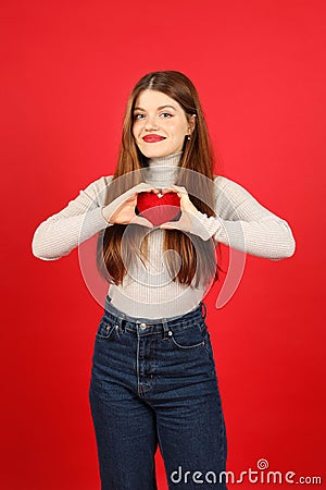 Social responsibility, a young woman blood donor holds a red heart in her hands Stock Photo
