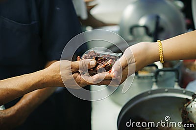 The Society of Sharing Food to Homeless and the Poorest: The Concept of Feeding : The hands of the rich give food to the hands of Stock Photo