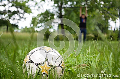 Socker ball in the garden with goalkeeper Stock Photo