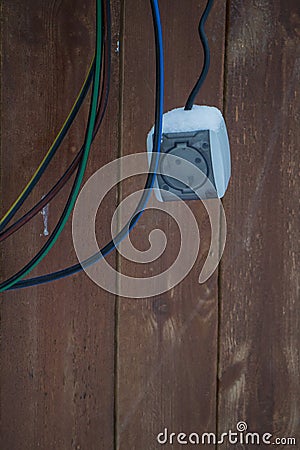 Socket with wires on a wooden background Stock Photo