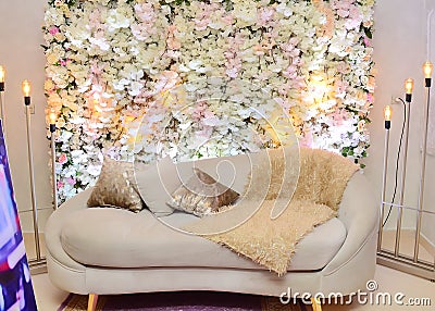 Sofa Amidst Flower Decorations On Stage In Wedding Stock Photo