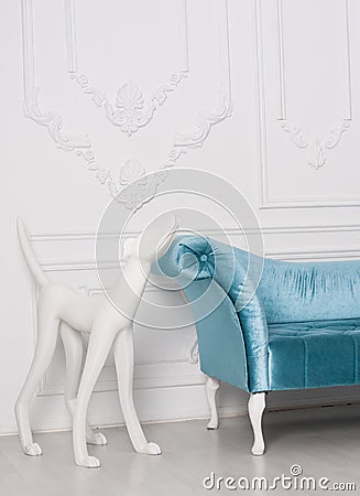 Sofa armrest with white sculpture of dog Stock Photo