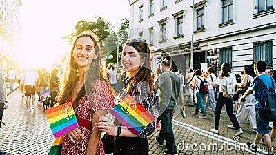 Sofia / Bulgaria - 10 June 2019: smiling Girls in LGBT parade with rainbow flag in the street. Gay and lesbian festival supporting Editorial Stock Photo