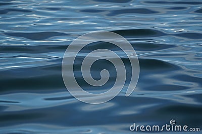 Soft abstract scene of blue sea water ripple freezing motion with sunlight reflection, shade and shadow, selective focus Stock Photo