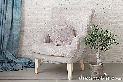 Soft armchair near brick wall. Stock Photo