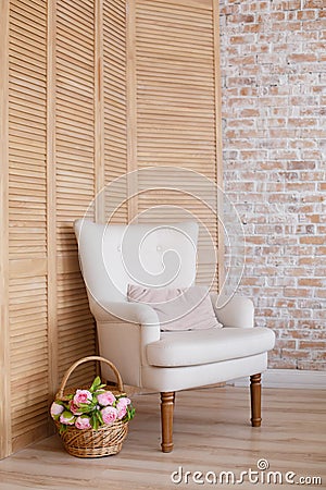 Soft armchair near brick wall. Stock Photo