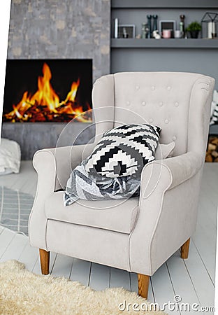 Soft armchair near the fireplace Stock Photo