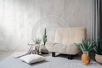 Soft armchair with plants in room interior design Stock Photo