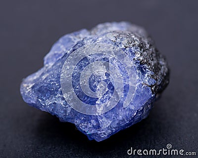 Soft blue violet rough TANZANITE from Tanzania isolated on black Stock Photo