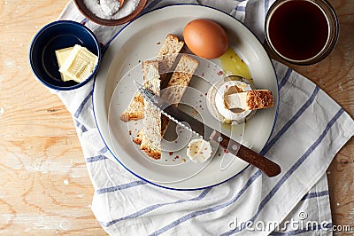 Soft boiled eggs with Buttered toast Soldiers are a classic English breakfast. Served with butter and cup of coffee Stock Photo