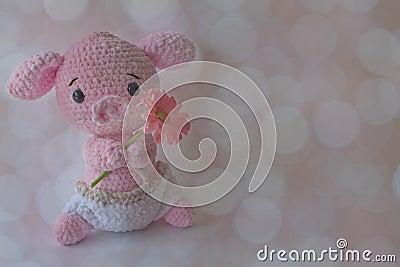 Soft crochet animal a holding flower Stock Photo