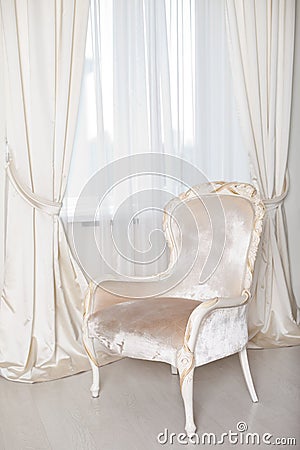 Soft elegant armchair near the window Stock Photo