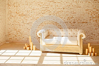 Soft elegant sofa near brick and wooden windows. Stock Photo