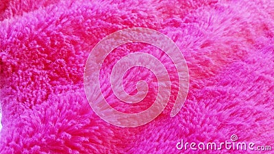 Soft faux fur of bright pink or fuchsia, laid in waves. Sample material for clothing, plush toys, plaids, bedspreads, covers and Stock Photo