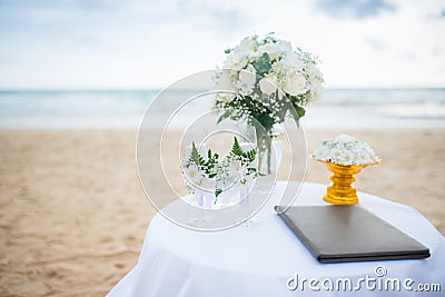 Flowers decorate at a wedding ceremony on the beach. Stock Photo