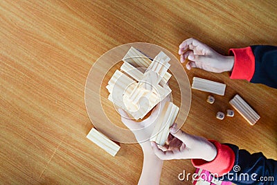 Soft focus hand of asian boy and his sister happy to play blocks wood game on wooden table Stock Photo