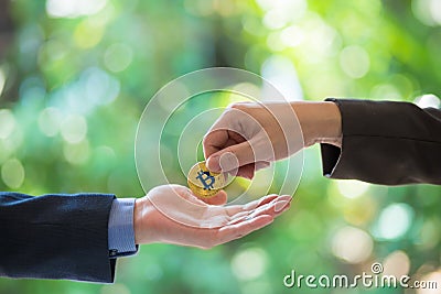Soft focus of Hands businessmen are trading coin of golden bitcoin. A symbolic coins of golden bitcoin. electronic money exchange, Stock Photo