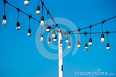 Soft focus light bulbs that decorate during celebrations or festivals on a bright sky background Stock Photo