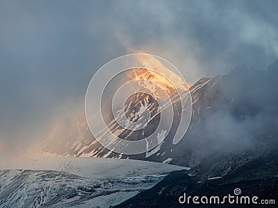 Soft focus. Minimalist mountain landscape with fiery snow peak. Wonderful minimalist landscape with big snowy mountain peaks above Stock Photo