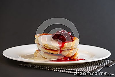 Plate with pancakes with sour cream and cherry syrup Stock Photo