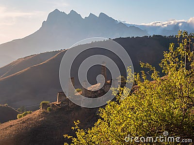 Soft focus. Tower village on the Tsei Loam pass. Sunset of Caucasus mountain in the Ingushetia. Medieval battle complex Pyaling is Stock Photo