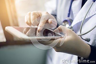 Soft focus of woman doctor hand holding and touching blank screen for work on modern smart phone in the consultation Stock Photo