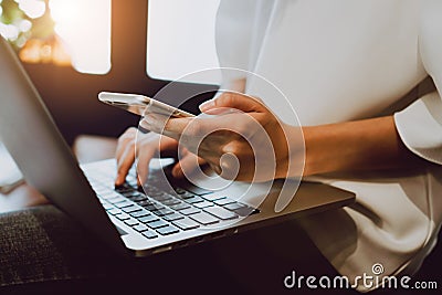 Soft focus of woman hand working with phone on desk in coffee shop. Vintage tone. Stock Photo