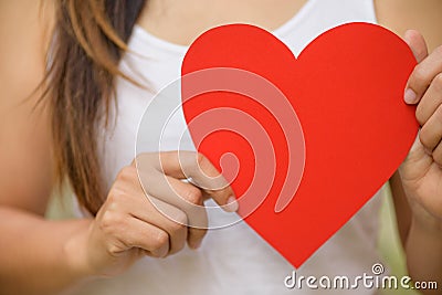 Soft focus of Woman holds handmade big red heart paper. Stock Photo