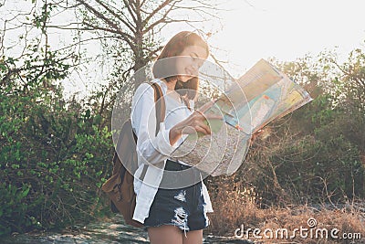 Soft focus of woman traveler with backpack checks map to find Path is a goal. vintage tone. Stock Photo