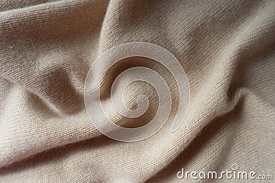 Soft folds of beige knitted fabric Stock Photo
