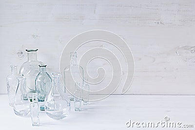 Soft home decor. Seashells and glass vase with spikelets on white wood background. Stock Photo