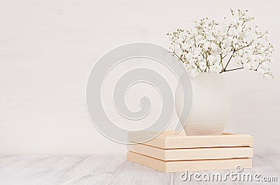 Soft home decor of white small flowers in ceramic vase on white wood background. Stock Photo