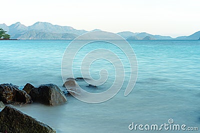 The soft indigo color ocean is smooth wave surface in the morning. Stock Photo