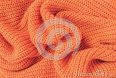 Soft knitted fabric from orange fluffy yarn. Stock Photo