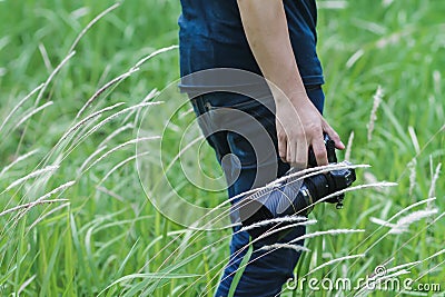 Soft Light and Blurred image, A photographer capturing the beautiful Grass flowers in the evening with a DSLR camera, Stock Photo