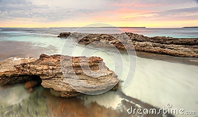 Soft pastel colours of a sunrise at Hyams Beach Australia Stock Photo