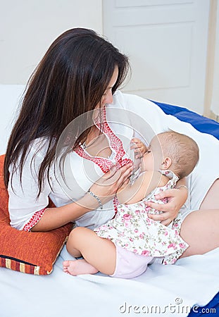 Soft photo young mother feeding breast her baby Stock Photo