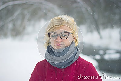 Soft portrait of odd lonely girl sitting in winter snowy forest. Friendless female person with sad emotional Stock Photo